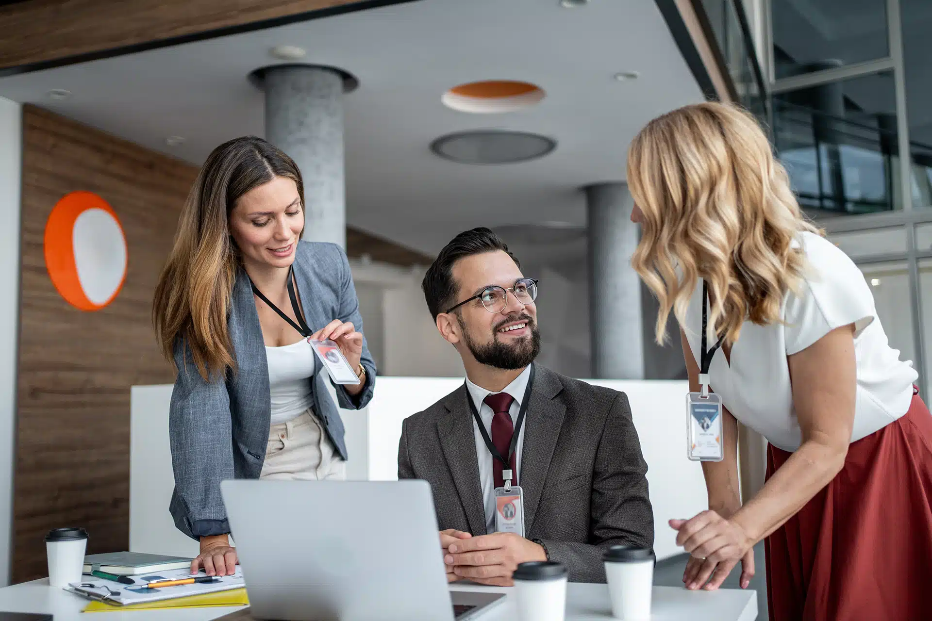 a team of employees discussing their new lanyards with standard ID card badge sizes