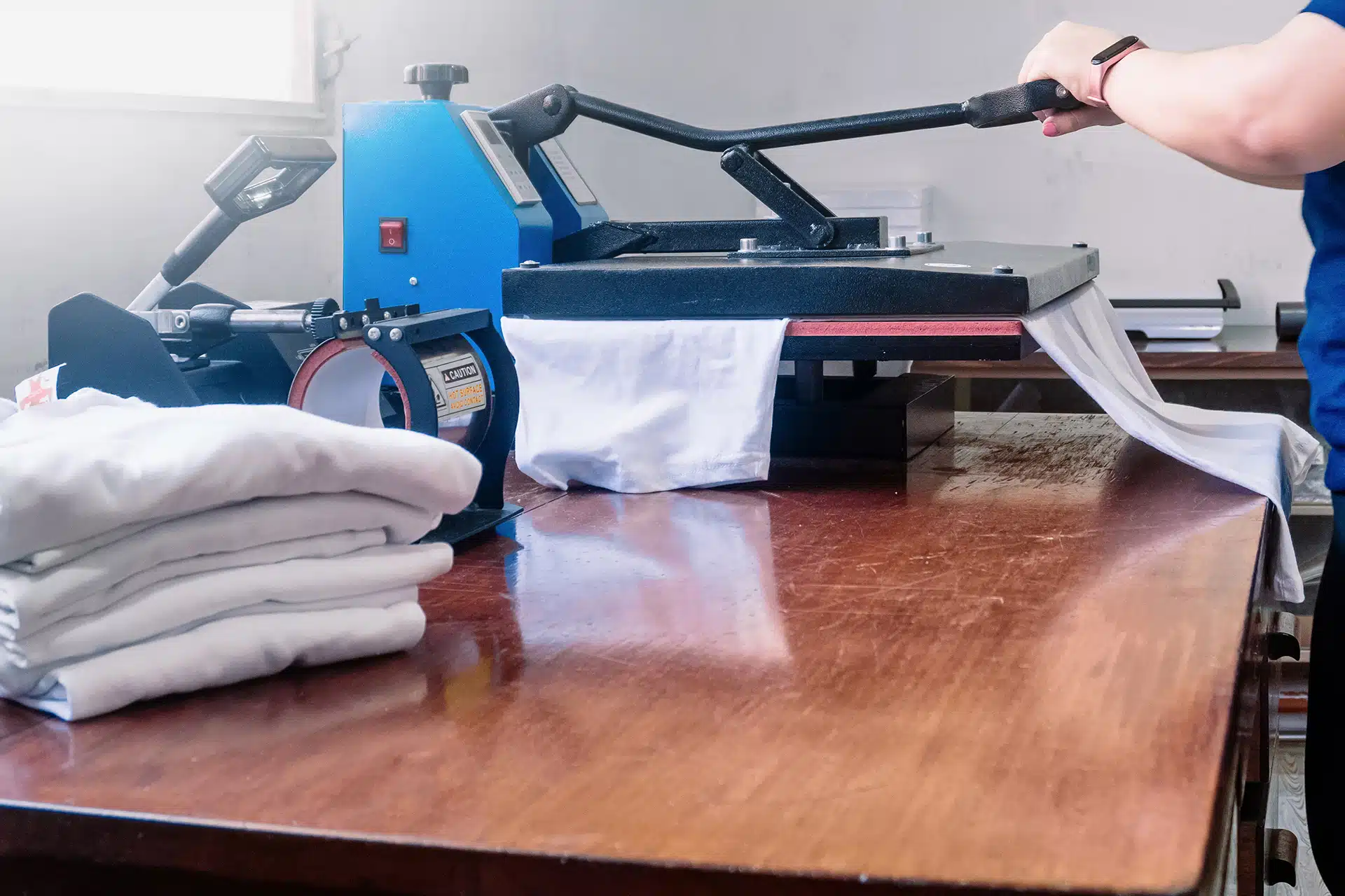 what is dye-sublimation printing - a heat press set up for printing t-shirts on a worktop